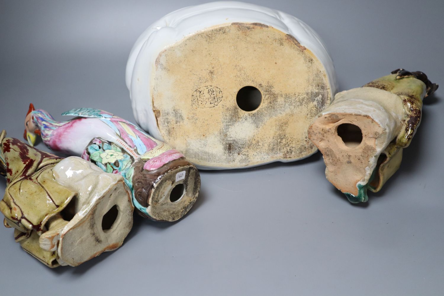 Four Chinese ceramic figures including Budai, 23cm, an enamelled phoenix, 24cm and two Chinese earthenware seated figures